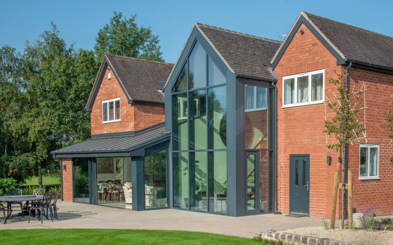 Two-storey side extension on a red-brick Cheshire home